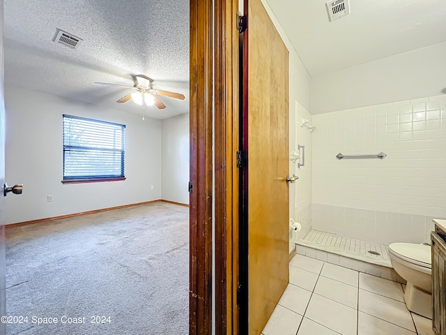 bathroom featuring a textured ceiling, vanity, toilet, and ceiling fan