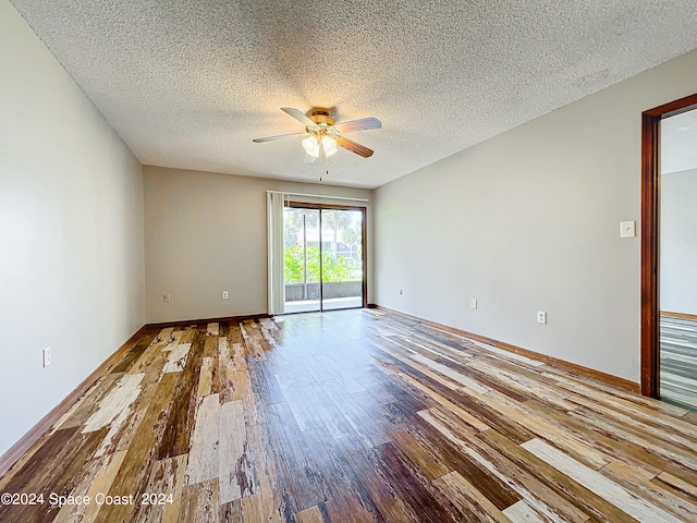 spare room with ceiling fan, a textured ceiling, and light wood-type flooring