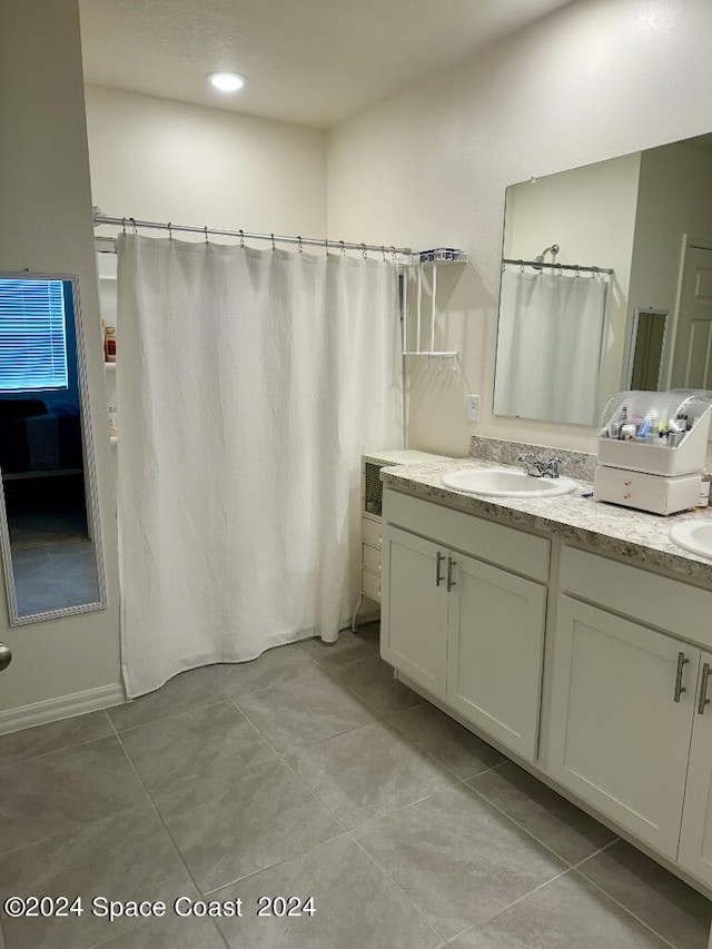 bathroom featuring vanity, tile patterned flooring, and curtained shower