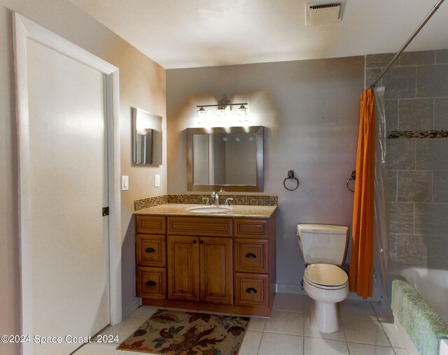 full bathroom featuring shower / tub combo with curtain, tile patterned floors, vanity, and toilet