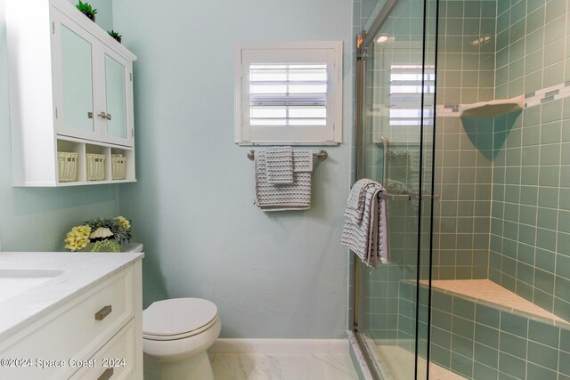 bathroom with vanity, toilet, and an enclosed shower