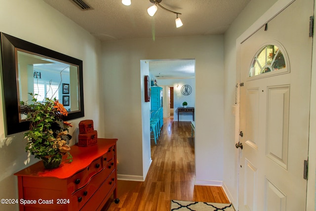 foyer featuring a textured ceiling and hardwood / wood-style floors