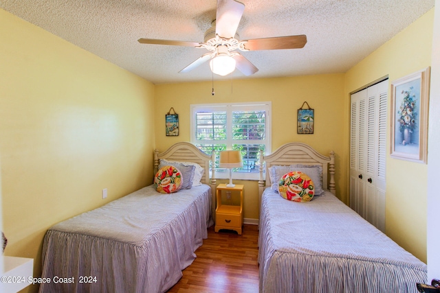 bedroom featuring a textured ceiling, hardwood / wood-style floors, ceiling fan, and a closet