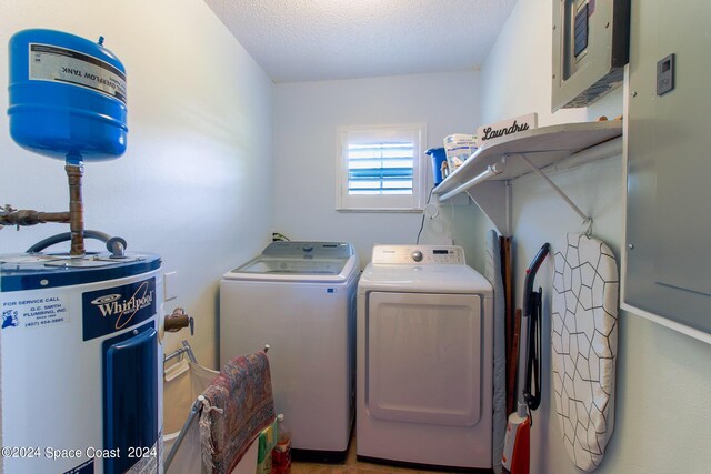 washroom featuring a textured ceiling, water heater, and separate washer and dryer