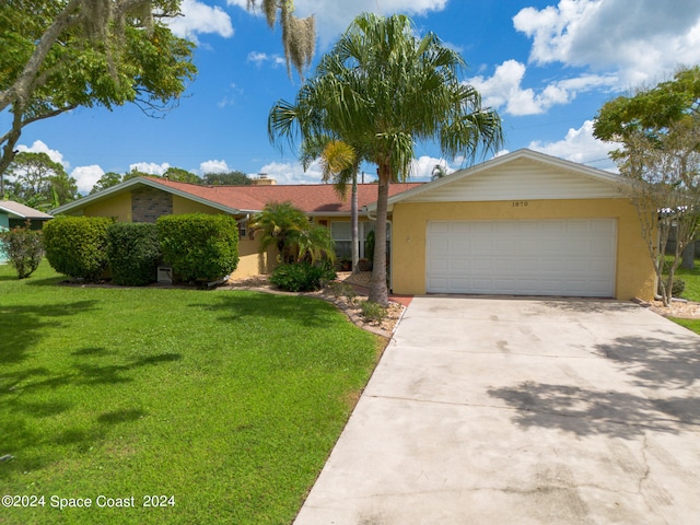 single story home featuring a front lawn and a garage