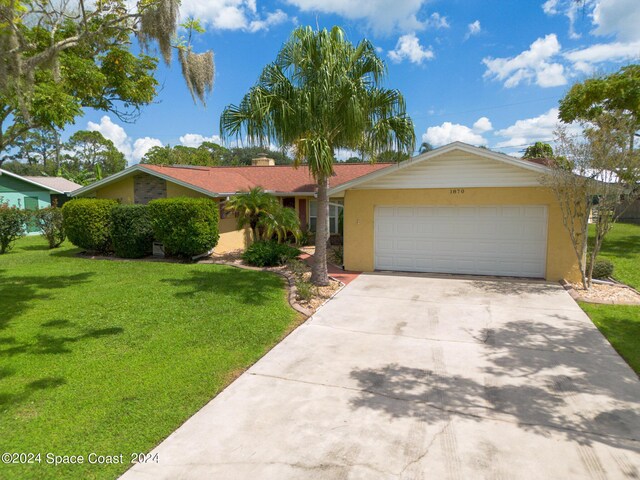 single story home featuring a garage and a front yard