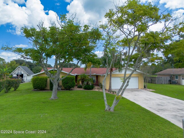 ranch-style home with a garage and a front lawn