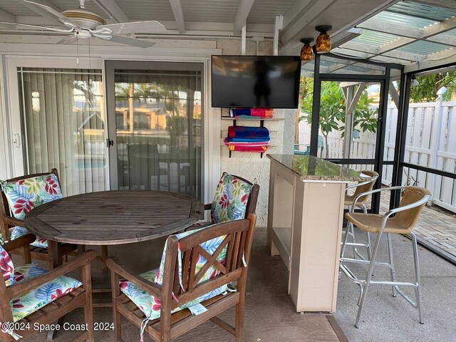 sunroom / solarium featuring ceiling fan