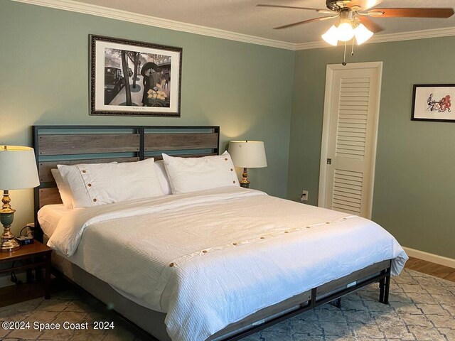 bedroom with wood-type flooring, ceiling fan, and crown molding