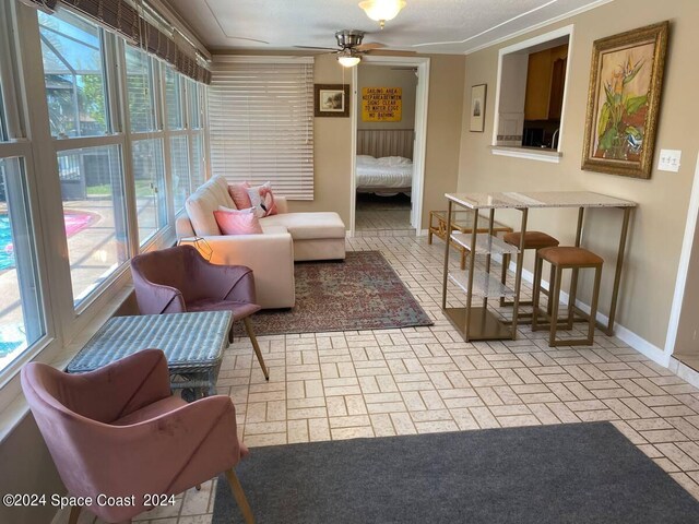 sunroom with ceiling fan and plenty of natural light