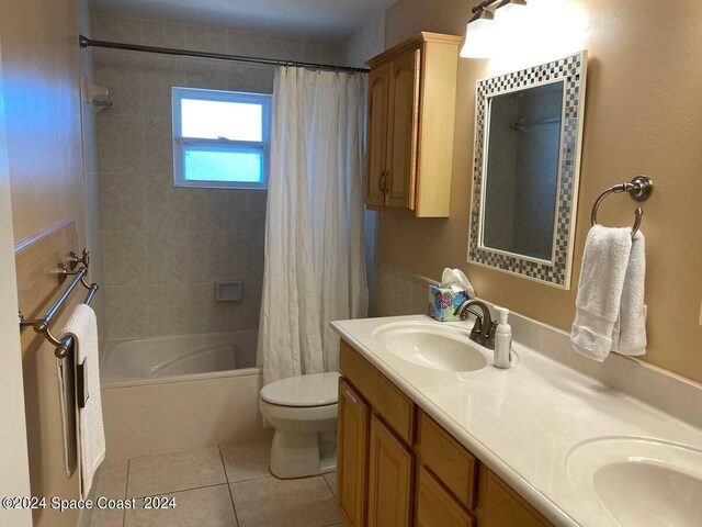 full bathroom with shower / bath combination with curtain, tile patterned flooring, vanity, and toilet