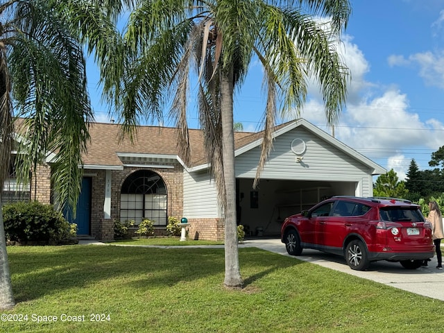 ranch-style home featuring a front lawn and a carport