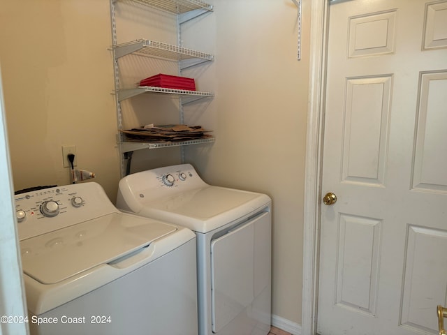 clothes washing area featuring washing machine and clothes dryer