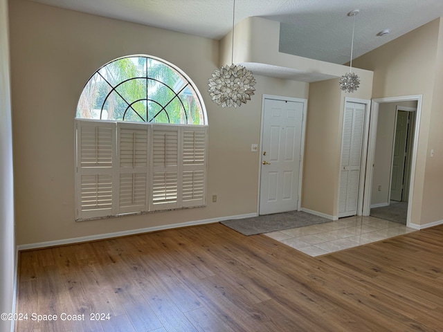 foyer entrance with light wood-type flooring and a textured ceiling