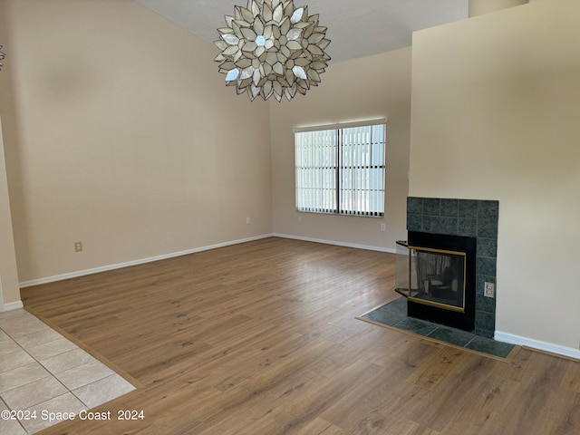 unfurnished living room with wood-type flooring and a fireplace