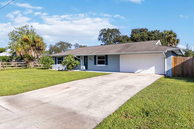 ranch-style house featuring a garage and a front lawn