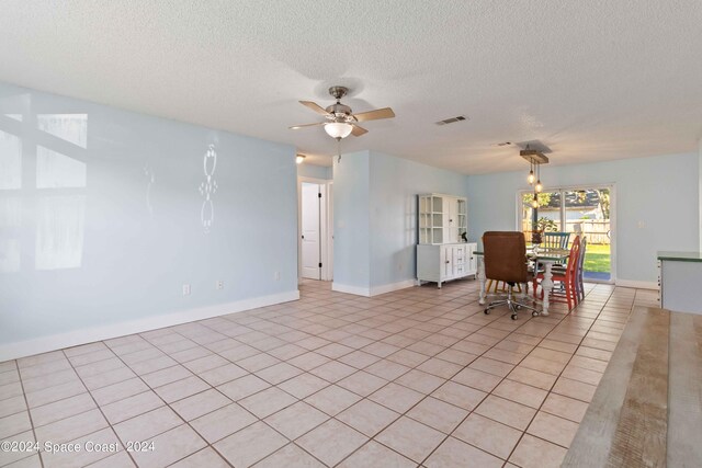 interior space featuring a textured ceiling and ceiling fan