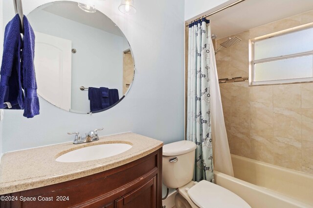 full bathroom with vanity, toilet, and shower / bathtub combination with curtain