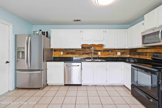 kitchen with stainless steel appliances, white cabinetry, a textured ceiling, and sink