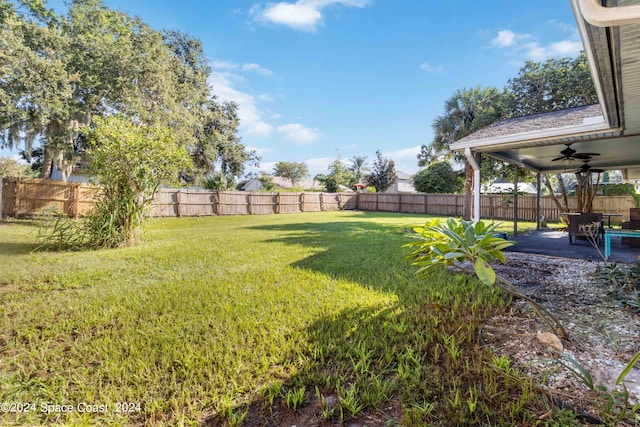 view of yard featuring ceiling fan and a patio area