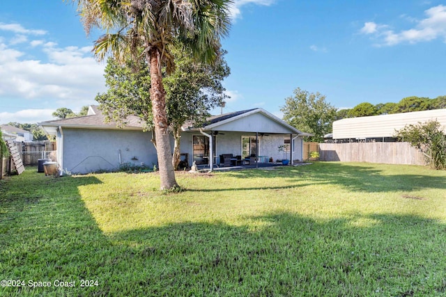 rear view of house featuring a yard and a patio area