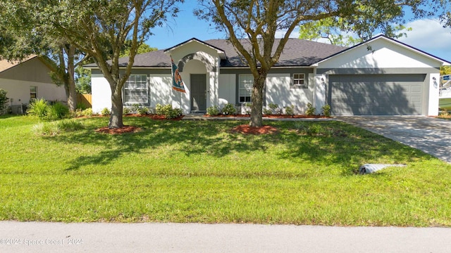 ranch-style home with a front lawn and a garage