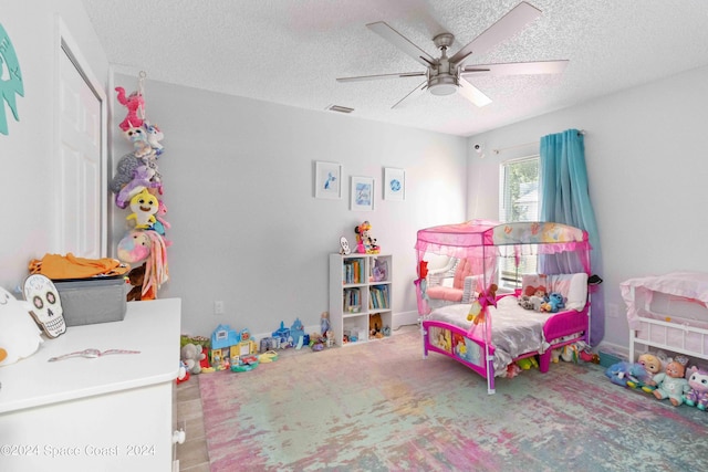 bedroom with wood-type flooring, a textured ceiling, and ceiling fan