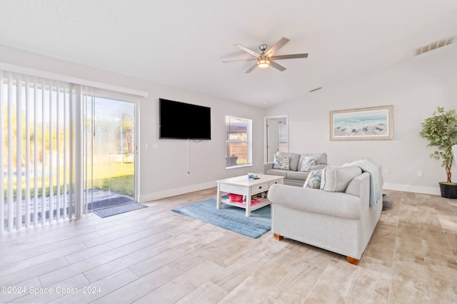 living room featuring light hardwood / wood-style floors, vaulted ceiling, and ceiling fan