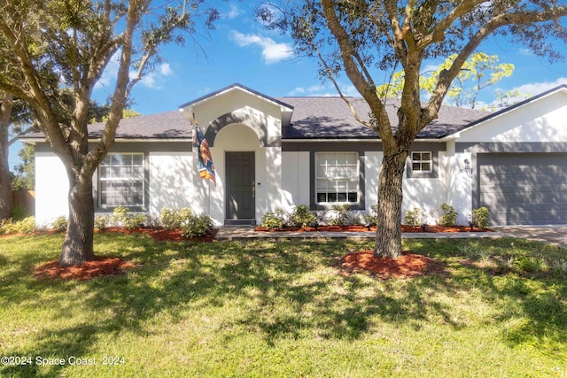 single story home with a garage and a front lawn