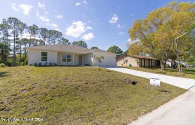 ranch-style home with a front yard and a garage