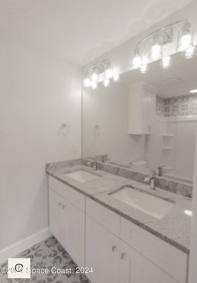 bathroom with tile patterned flooring and vanity