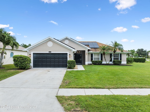 ranch-style house featuring a front yard and a garage