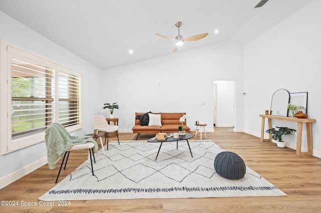 sitting room with high vaulted ceiling, ceiling fan, and light wood-type flooring