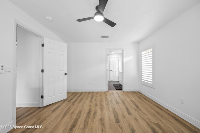 unfurnished bedroom featuring ensuite bath, ceiling fan, and light hardwood / wood-style flooring