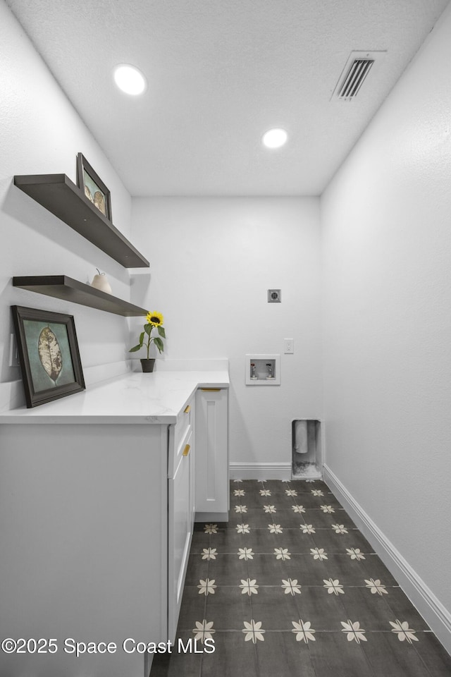 laundry area with cabinets, hookup for a washing machine, and electric dryer hookup