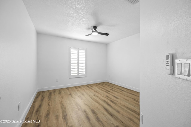 spare room featuring hardwood / wood-style floors, a textured ceiling, and ceiling fan