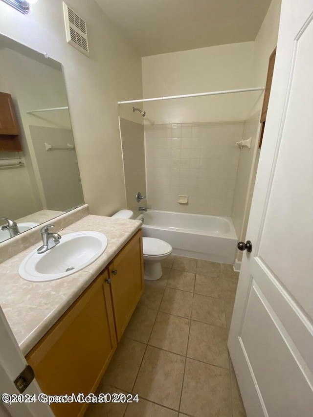 full bathroom featuring tile patterned floors, tiled shower / bath combo, vanity, and toilet