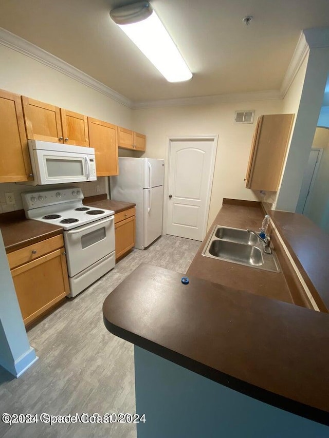 kitchen with ornamental molding, light wood-type flooring, white appliances, and sink