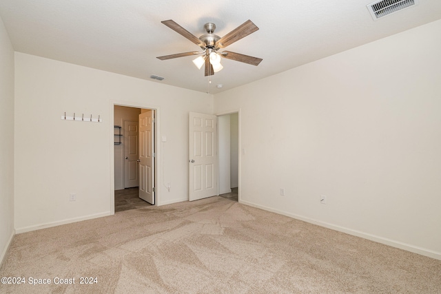 unfurnished bedroom with light carpet and ceiling fan