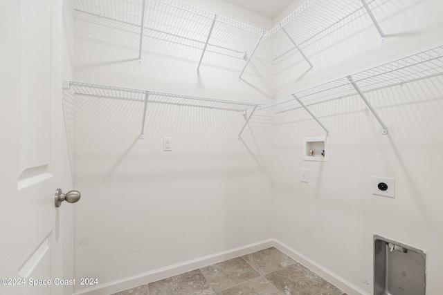 clothes washing area featuring hookup for an electric dryer and hookup for a washing machine