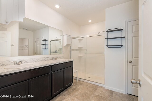 bathroom featuring vanity and an enclosed shower