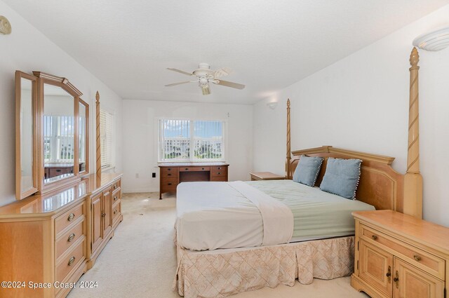 bedroom featuring ceiling fan and light colored carpet