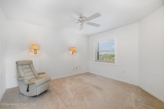 sitting room featuring ceiling fan and light carpet