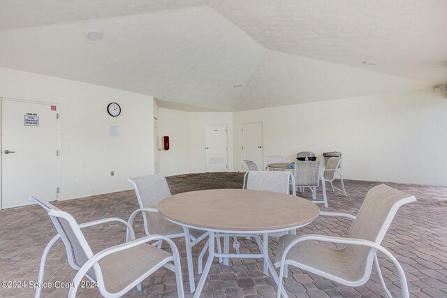 dining space featuring lofted ceiling