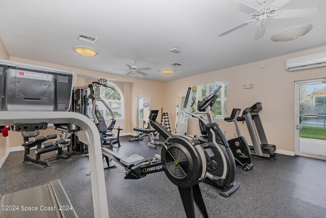 gym featuring ceiling fan and a wall mounted air conditioner