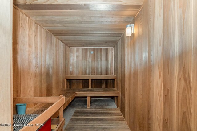 view of sauna / steam room featuring wood ceiling and wooden walls