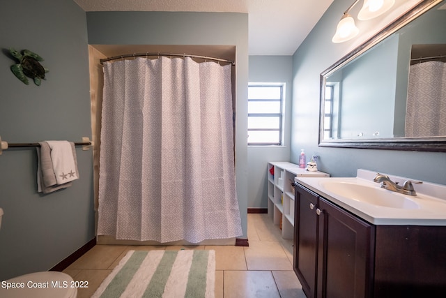 bathroom featuring a shower with shower curtain, tile patterned floors, vanity, and toilet