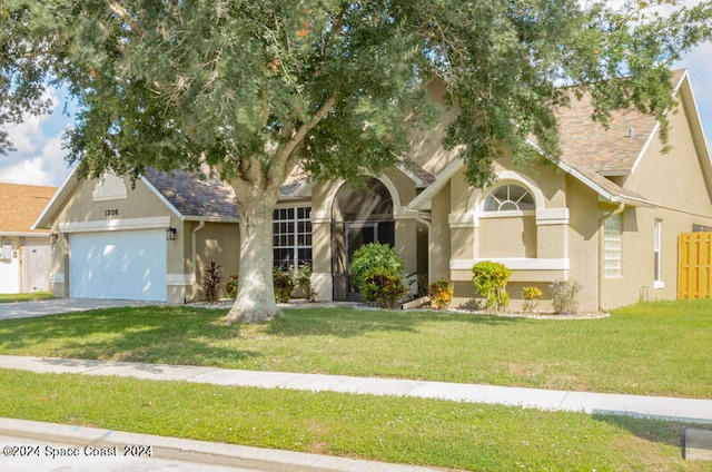 view of front facade with a front lawn and a garage