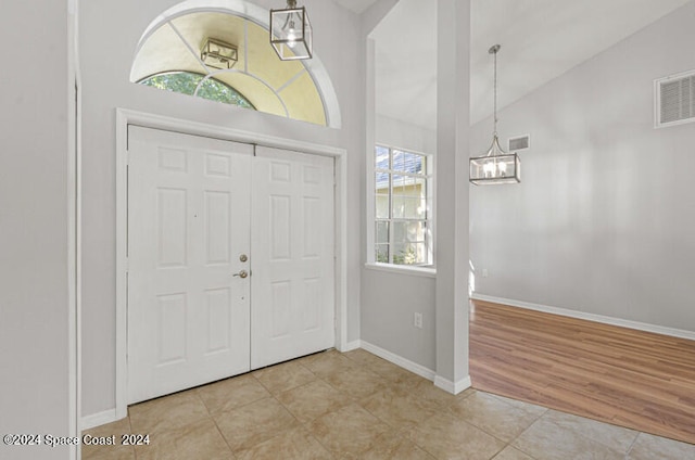 entryway featuring light hardwood / wood-style flooring and vaulted ceiling