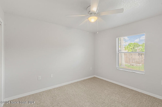 carpeted empty room with ceiling fan